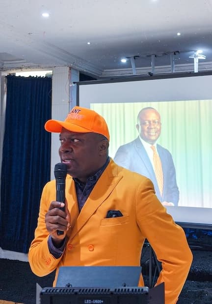 A Valiant leader in an orange cap addressing members